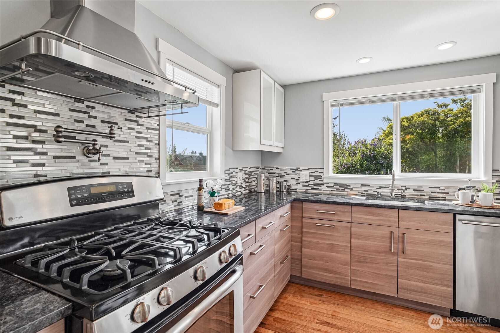 7313 25th Avenue Northwest Seattle, WA 98117 - Photo 9 of 40 a kitchen with sink stove and cabinets