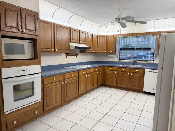 a kitchen with stainless steel appliances a stove sink and microwave