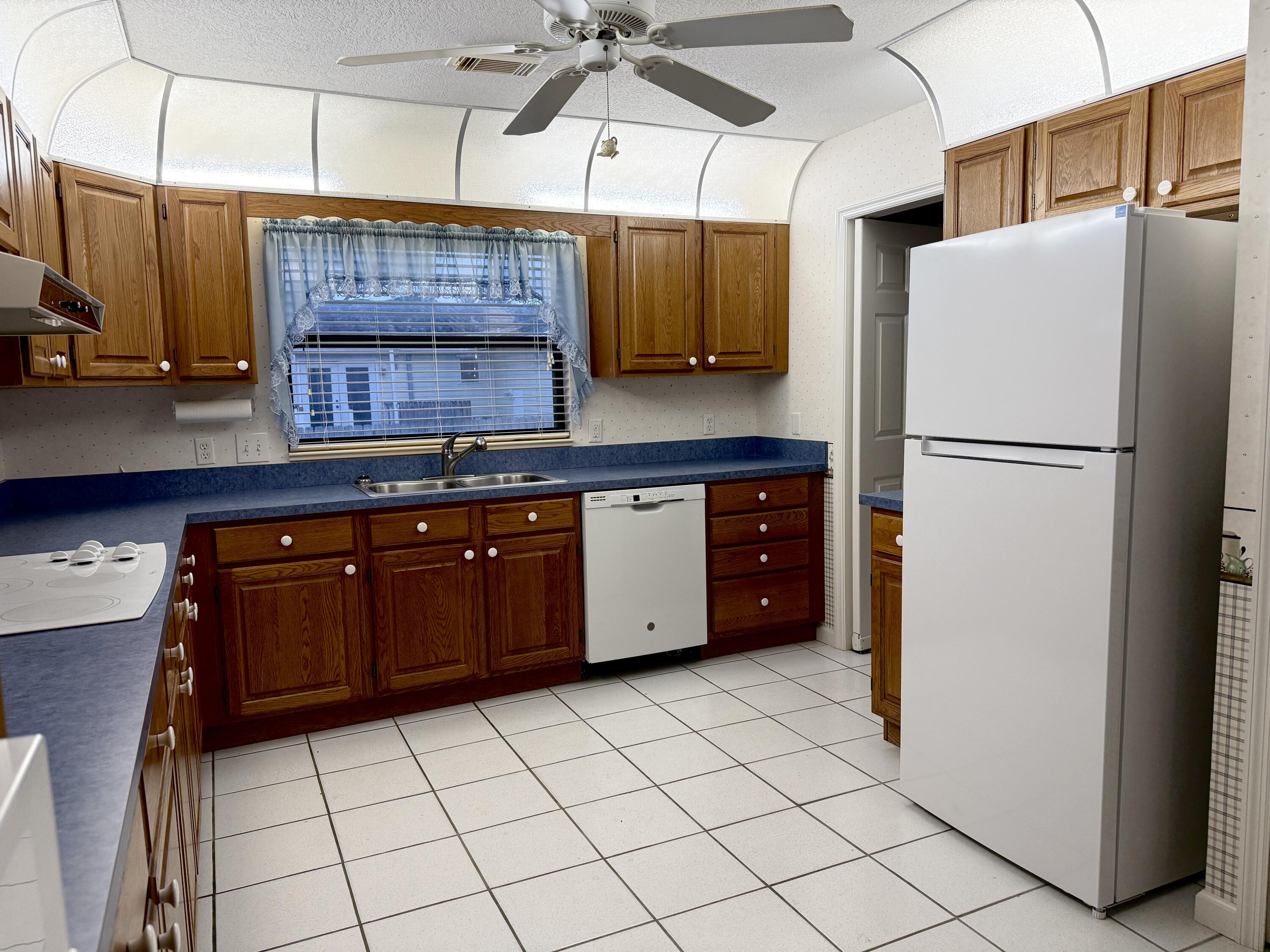 6539 Southeast Held Court Stuart, FL 34997 - Photo 14 of 34 a kitchen with stainless steel appliances a refrigerator and a sink