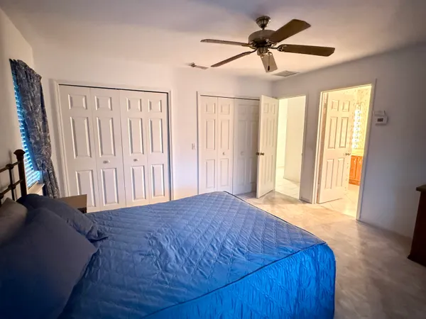 a view of a livingroom with a ceiling fan and window