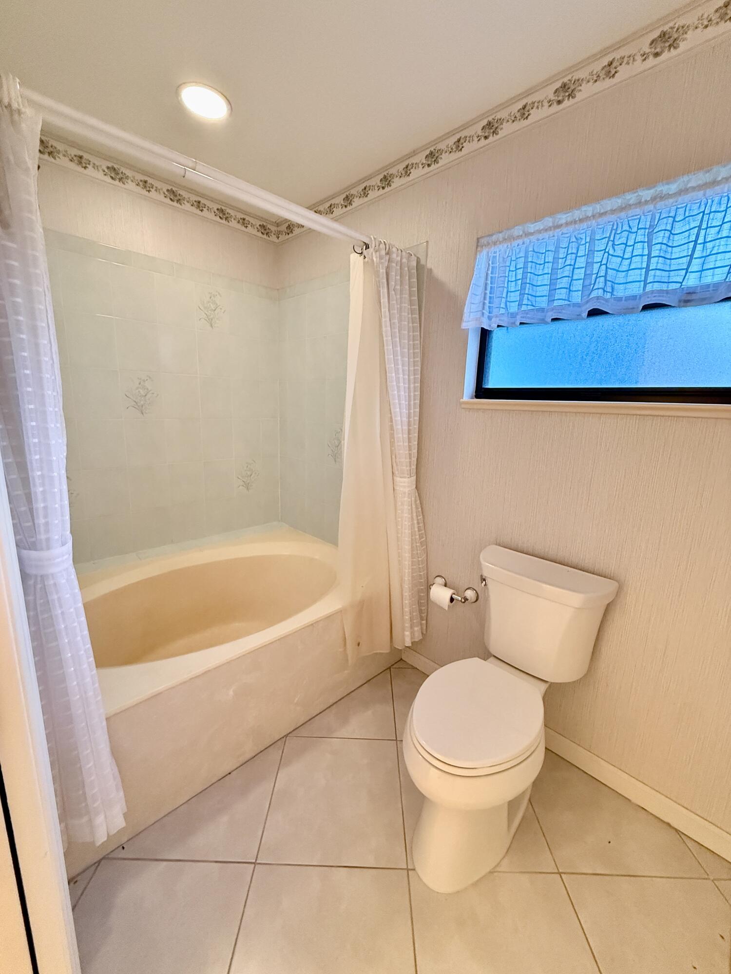 6539 Southeast Held Court Stuart, FL 34997 - Photo 20 of 34 a bathroom with a toilet and a shower
