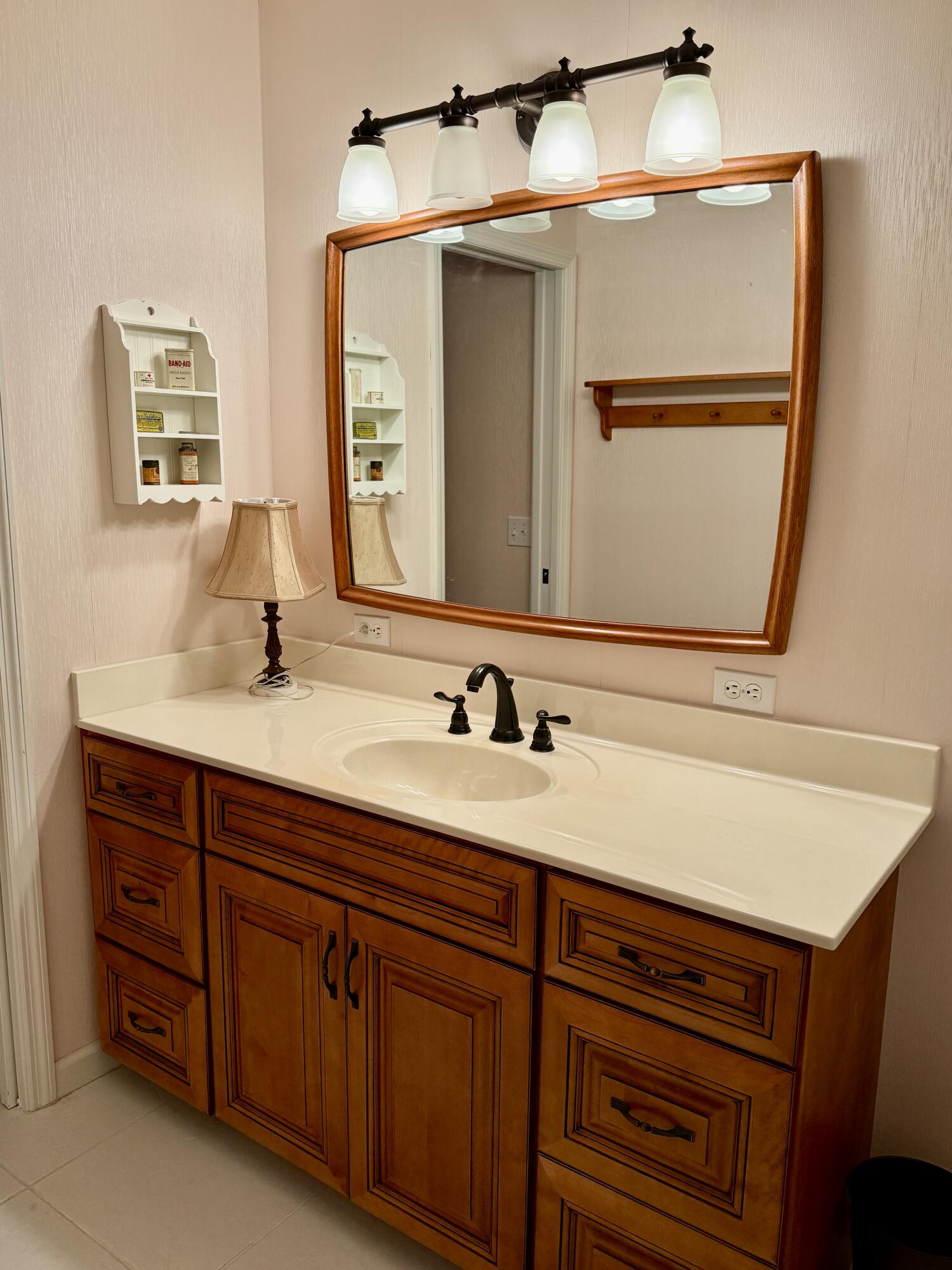 6539 Southeast Held Court Stuart, FL 34997 - Photo 24 of 34 a bathroom with a sink and a mirror