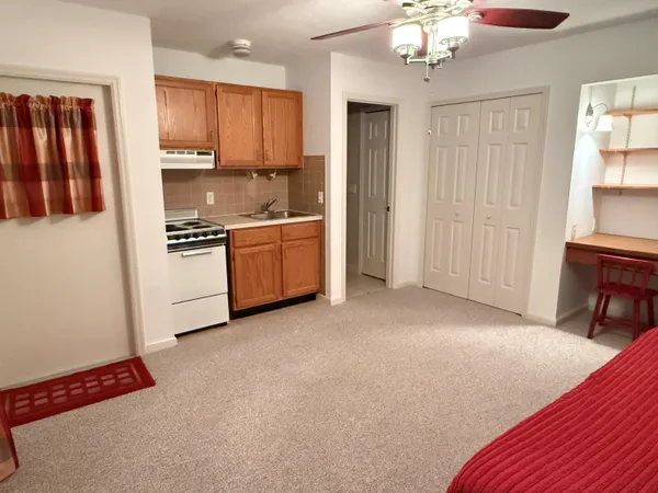 a kitchen with stainless steel appliances granite countertop a refrigerator a stove top oven a sink and dishwasher