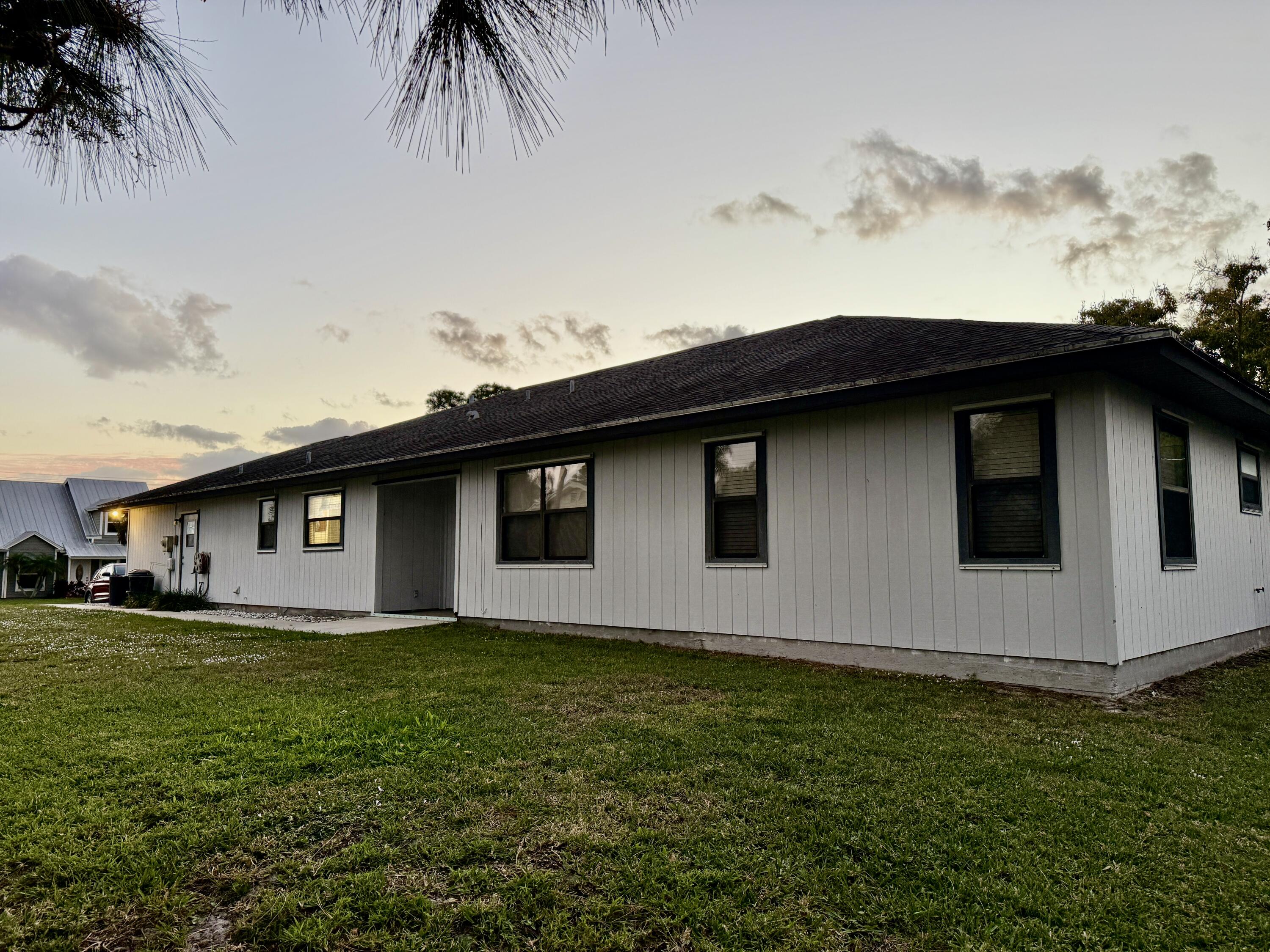 6539 Southeast Held Court Stuart, FL 34997 - Photo 30 of 34 a backyard of a house with lots of green space