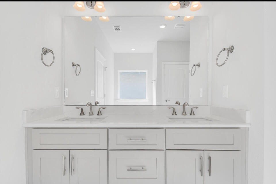 593 Alleyoak Lane, Unit 102 Freeport, FL 32439 - Photo 11 of 17 a bathroom with double sink and a mirror