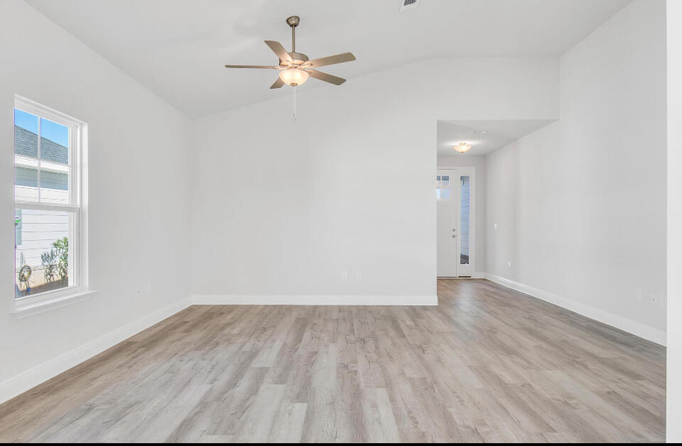 593 Alleyoak Lane, Unit 102 Freeport, FL 32439 - Photo 7 of 17 wooden floor in an empty room with a window