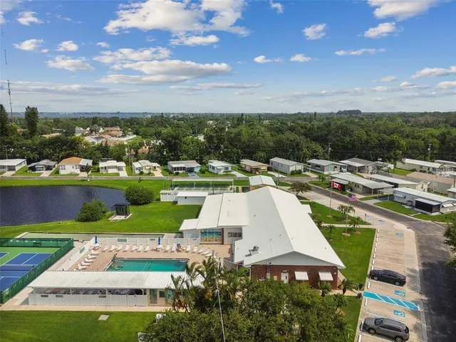 a green field with some trees in front of it