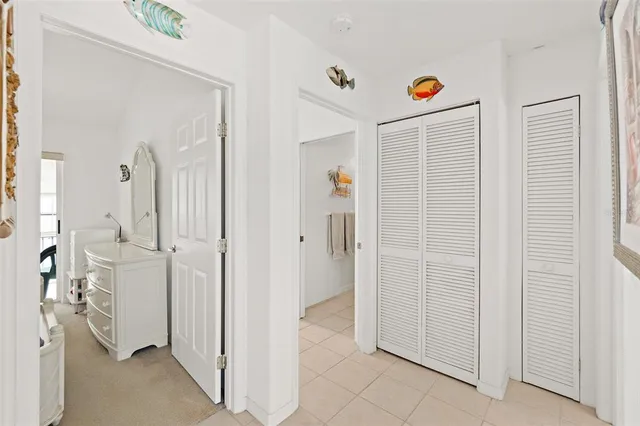 a bedroom with two beds and a chandelier