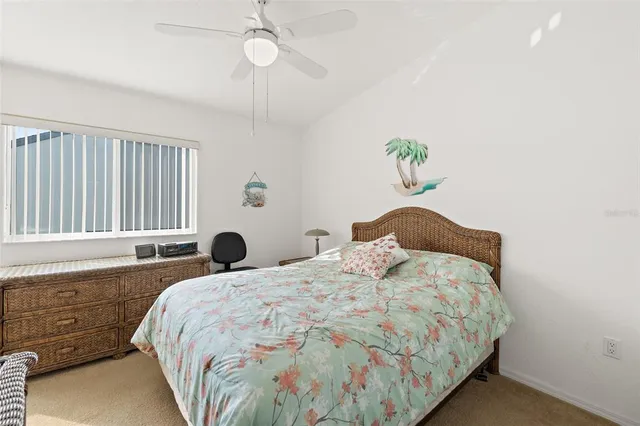 a bedroom with a bed and a flat tv screen on the dresser