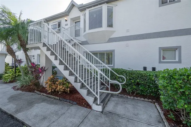a view of a house with wooden stairs in front
