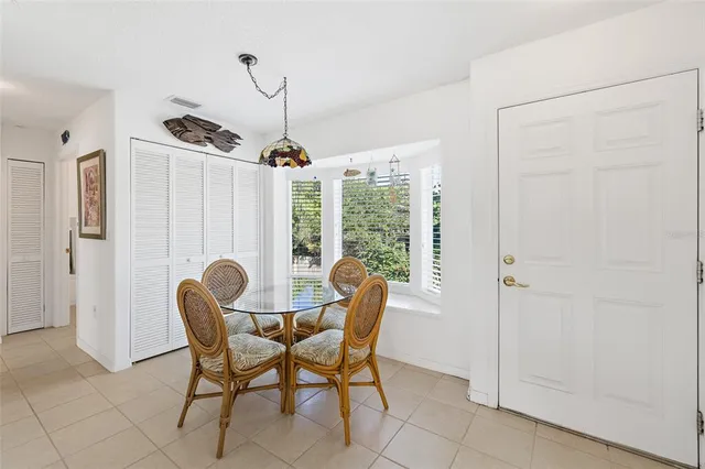 a dining room with furniture and window