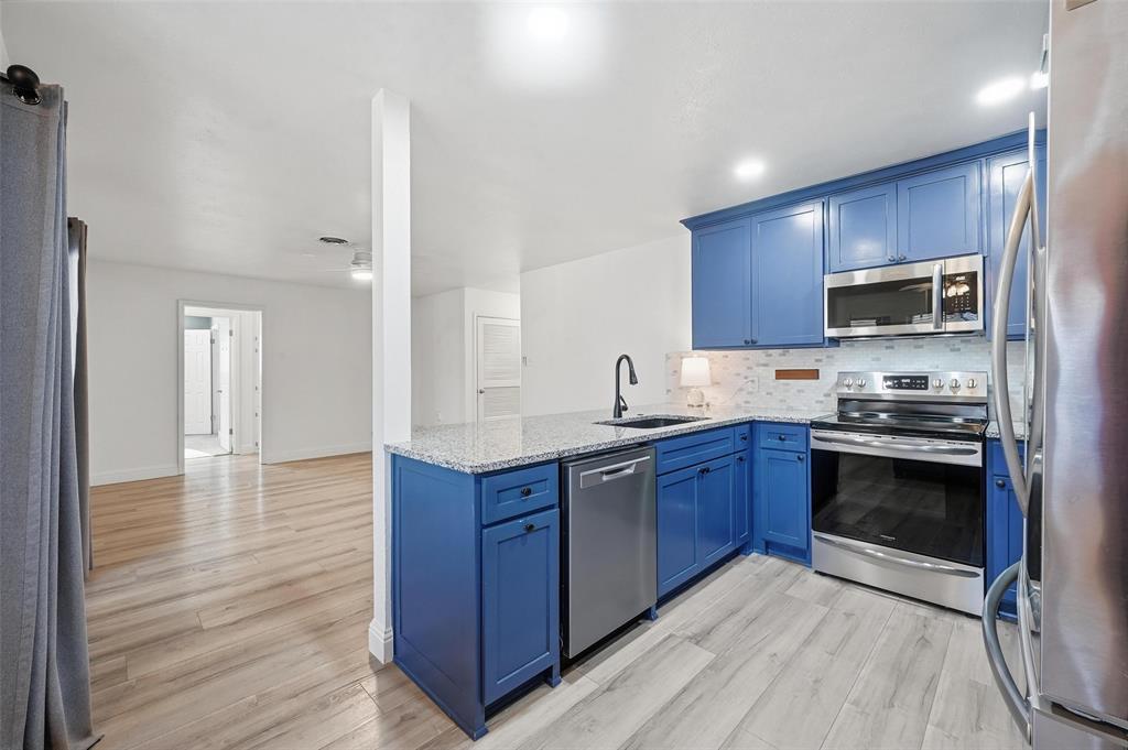1164 Valley View Drive Hurst, TX 76053 - Photo 11 of 21 Kitchen has been update with granite, backsplash, soft close cabinetry as well as SS range, dishwasher and microwave