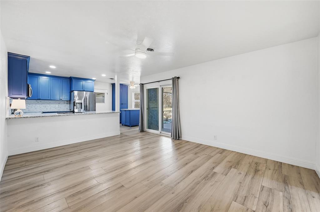 1164 Valley View Drive Hurst, TX 76053 - Photo 6 of 21 Kitchen opens to a secondary living space. Sliding doors lead to the covered back patio and large, fenced back yard.