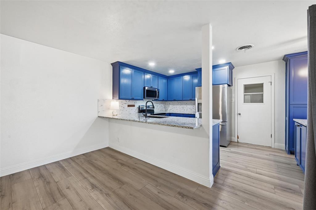 1164 Valley View Drive Hurst, TX 76053 - Photo 9 of 21 Granite counters open to the living space. Easily fit 4 barstools to enjoy this area for extra seating