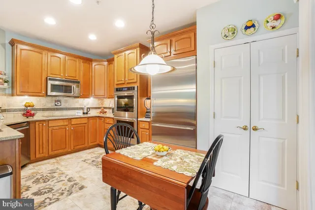 a kitchen with a refrigerator a stove top oven a sink and dishwasher