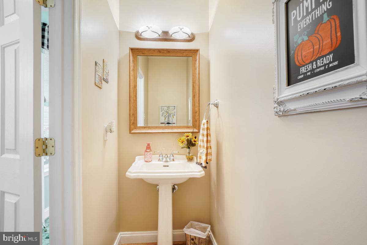 7606 Vulpe Court Odenton, MD 21113 - Photo 24 of 45 a bathroom with a sink a mirror and a toilet