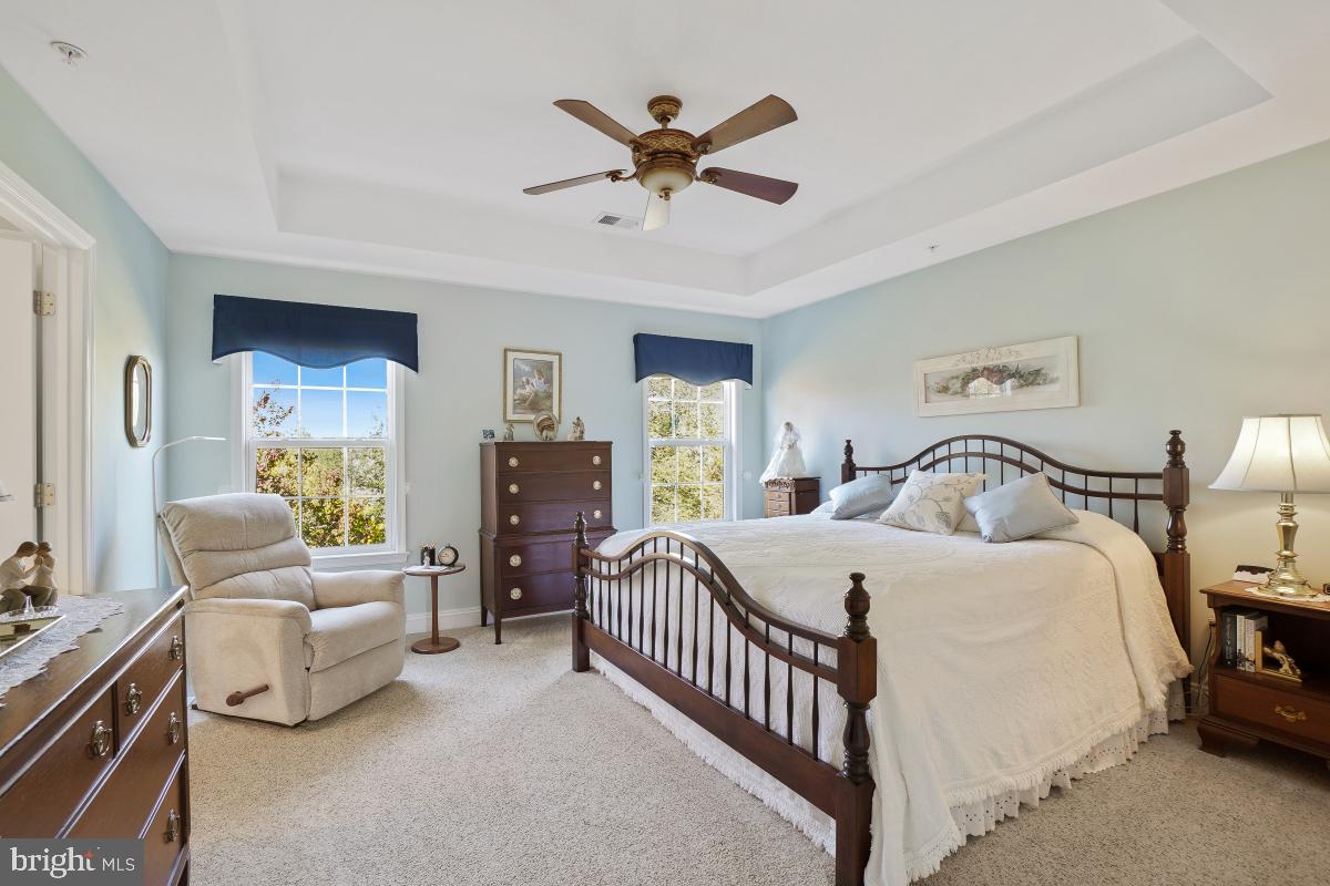 7606 Vulpe Court Odenton, MD 21113 - Photo 33 of 45 a bedroom with a bed and a chandelier