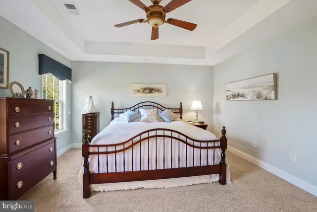 a spacious bathroom with a tub sink and mirror
