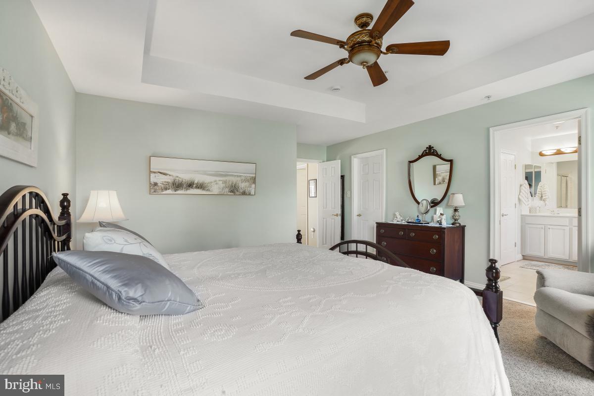 7606 Vulpe Court Odenton, MD 21113 - Photo 35 of 45 a bedroom with a large bed and a chandelier