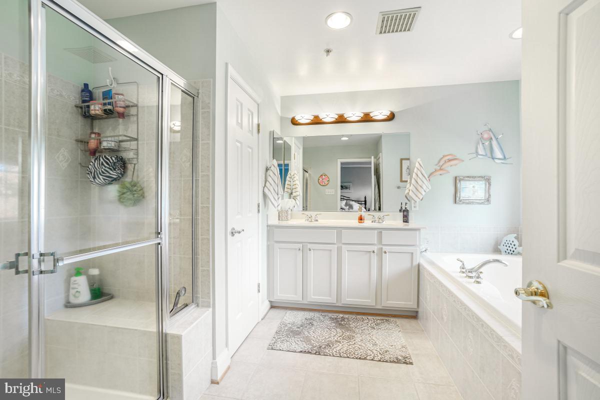 7606 Vulpe Court Odenton, MD 21113 - Photo 36 of 45 a spacious bathroom with a tub sink and mirror