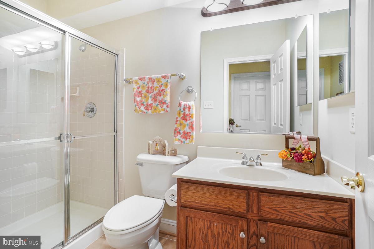 7606 Vulpe Court Odenton, MD 21113 - Photo 41 of 45 a bathroom with a sink mirror vanity and toilet