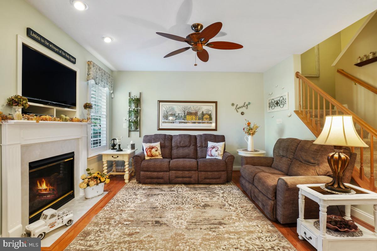 7606 Vulpe Court Odenton, MD 21113 - Photo 10 of 45 a living room with furniture a flat screen tv and a fireplace