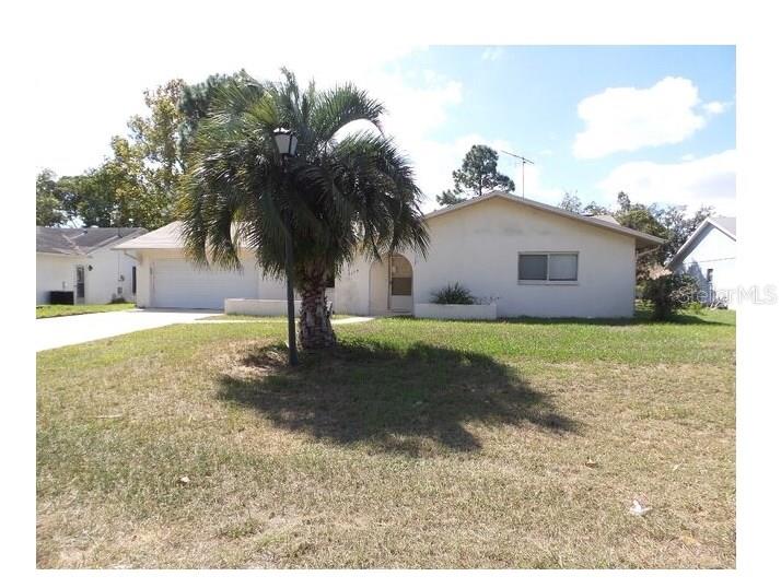 5085 Elwood Road Spring Hill, FL 34608 - Photo 1 of 1 a view of a yard with a house