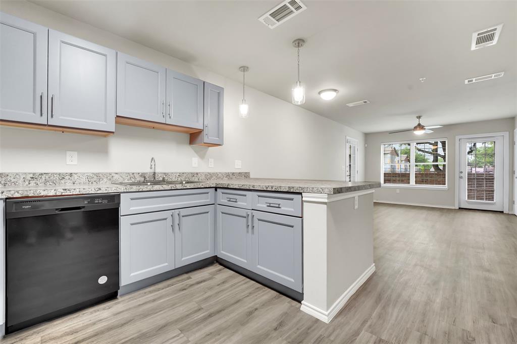 6108 Abrams Road, Unit 201 Dallas, TX 75231 - Photo 4 of 19 a kitchen with granite countertop white cabinets and white appliances