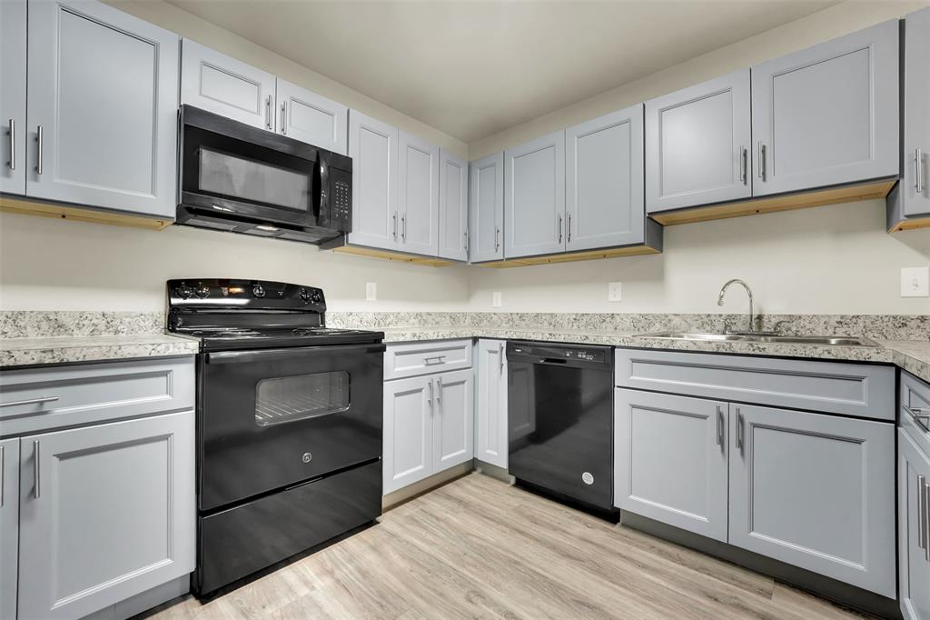 6108 Abrams Road, Unit 201 Dallas, TX 75231 - Photo 5 of 19 a kitchen with granite countertop white cabinets stainless steel appliances and a sink
