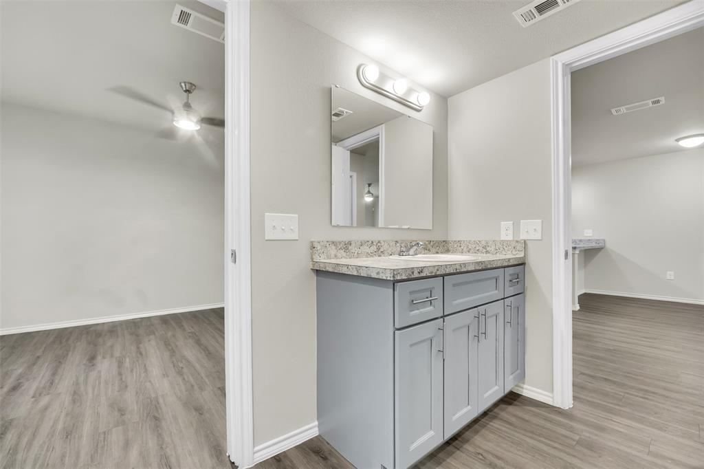 6108 Abrams Road, Unit 201 Dallas, TX 75231 - Photo 10 of 19 a bathroom with a sink and a mirror
