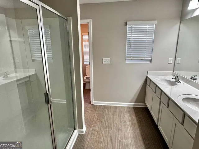 a bathroom with a sink a mirror and a shower