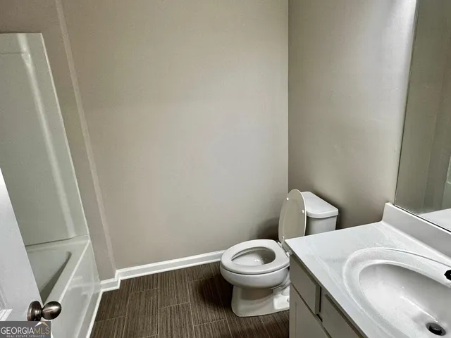 a white toilet sitting next to a sink