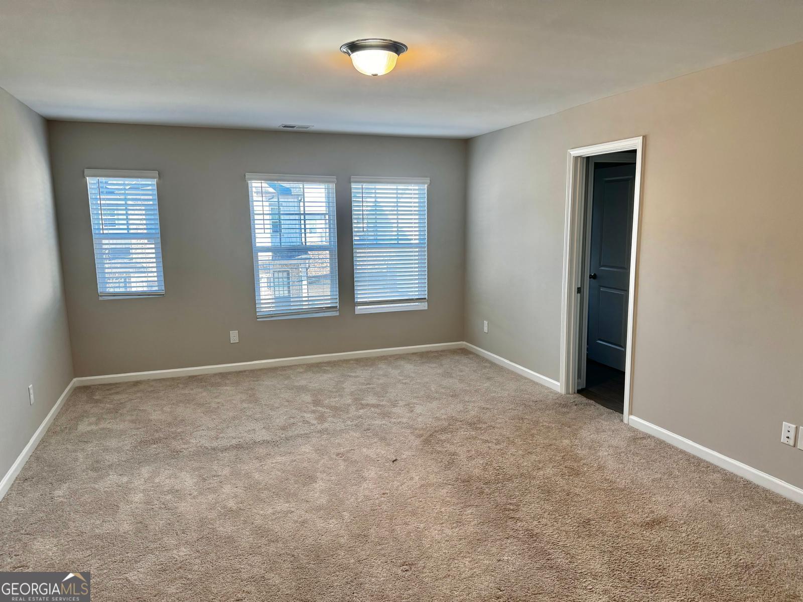 1397 Ben Park Way Grayson, GA 30017 - Photo 4 of 17 an empty room with windows