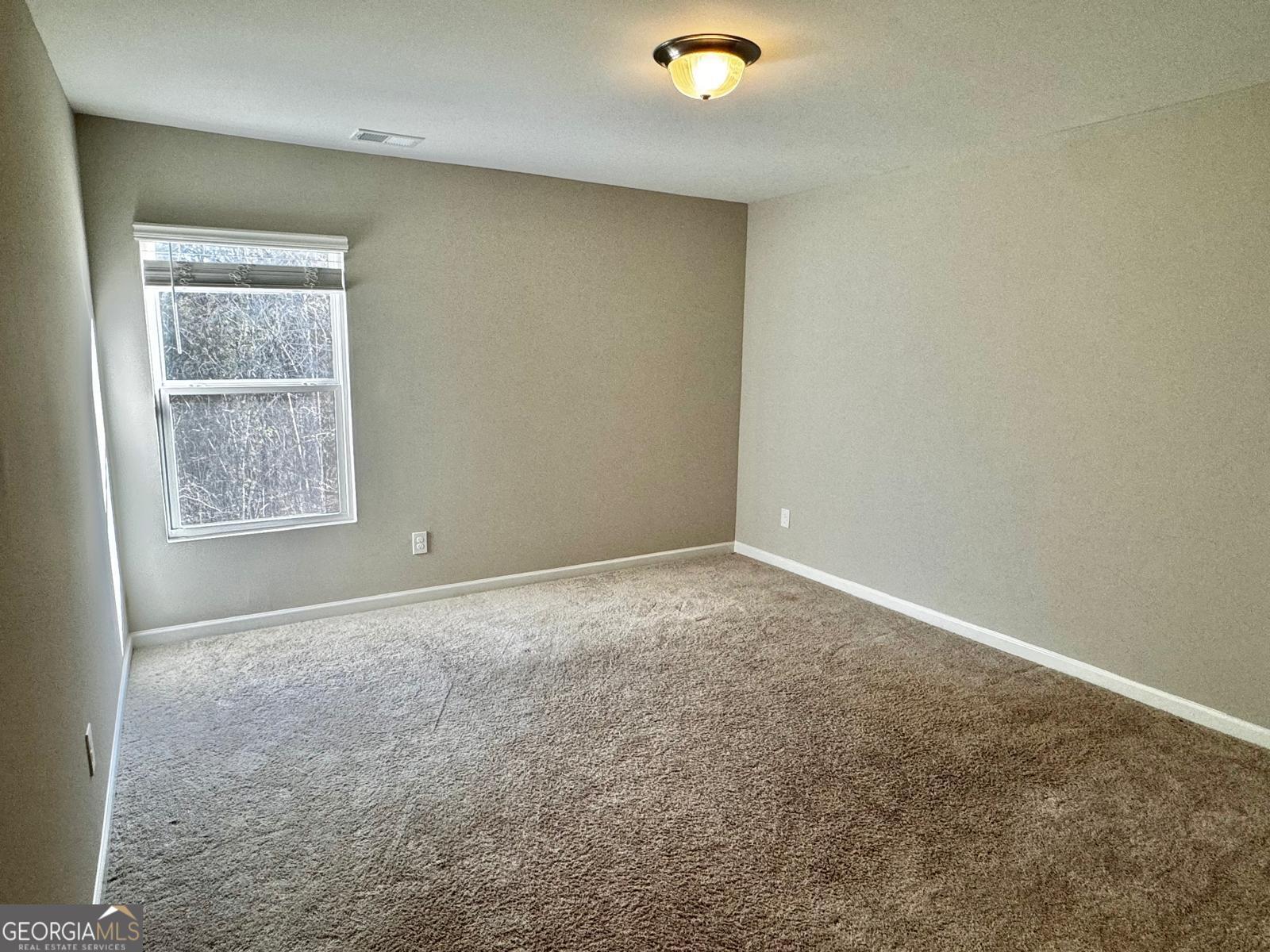 1397 Ben Park Way Grayson, GA 30017 - Photo 10 of 17 an empty room with windows