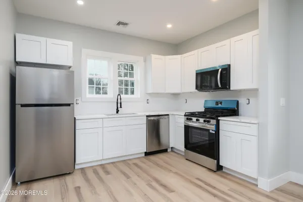 a kitchen with a refrigerator stove and microwave