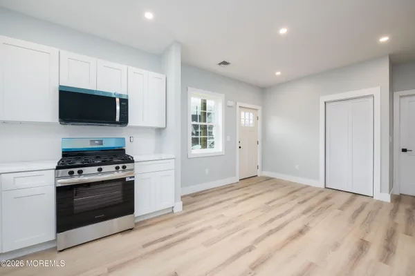a kitchen with a stove and a microwave