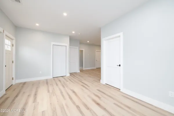 a view of an empty room and wooden floor
