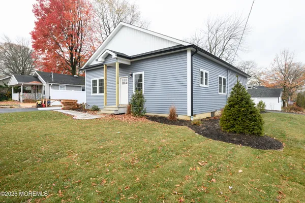 a backyard of a house with yard and outdoor seating
