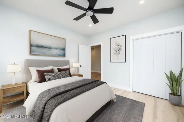 a bedroom with bed and a chandelier