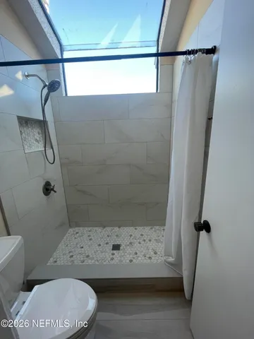 a bathroom with a toilet and shower