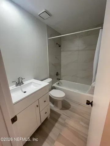 a bathroom with a sink mirror toilet and bathtub
