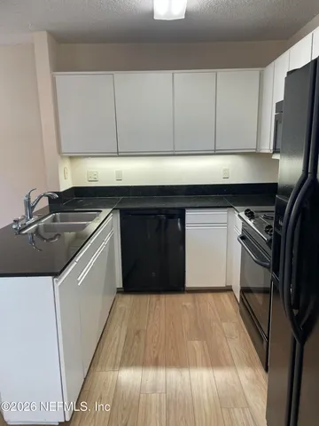 a kitchen with a sink and a stove top oven
