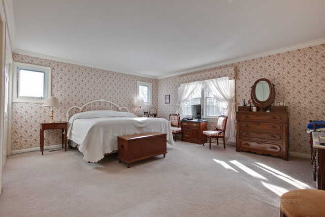 385 Old Sutton Road Barrington Hills, IL 60010 - Photo 13 of 25 a spacious bedroom with a bed a closet and large window