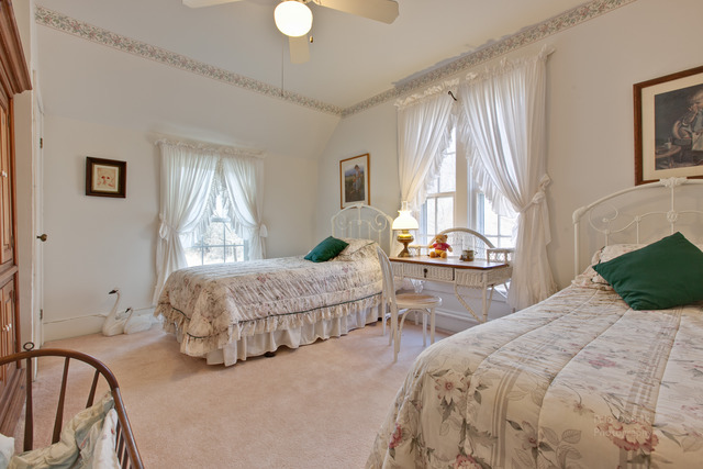 385 Old Sutton Road Barrington Hills, IL 60010 - Photo 15 of 25 a bedroom with a bed and potted plants next to a large window