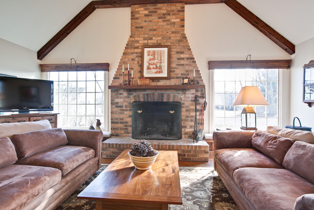 385 Old Sutton Road Barrington Hills, IL 60010 - Photo 3 of 25 a living room with furniture fireplace and a flat screen tv