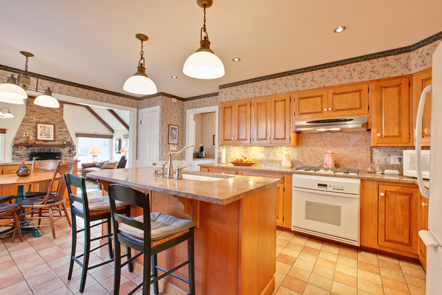 385 Old Sutton Road Barrington Hills, IL 60010 - Photo 4 of 25 a kitchen with stainless steel appliances granite countertop a sink a stove and chairs