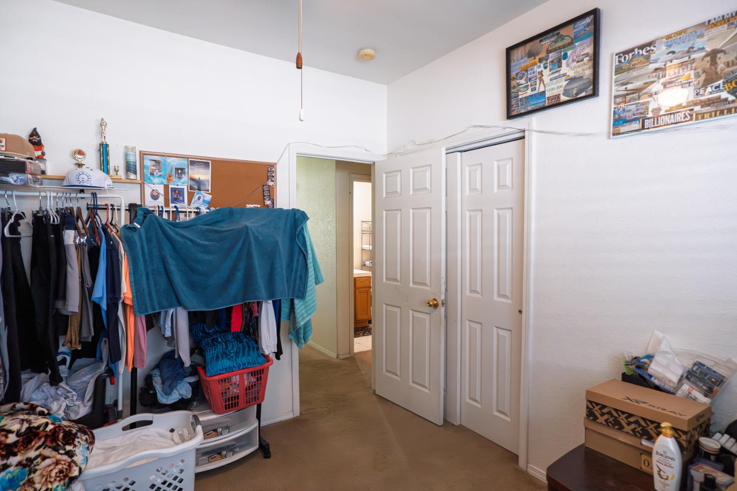 123 Manzanita Avenue Merced, CA 95341 - Photo 14 of 30 a view of walk in closet with clothes and shoes