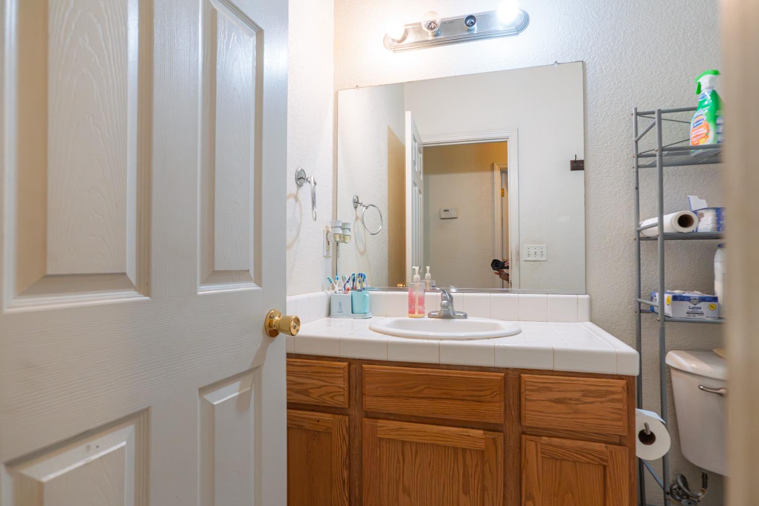 123 Manzanita Avenue Merced, CA 95341 - Photo 15 of 30 a bathroom with a sink and a mirror