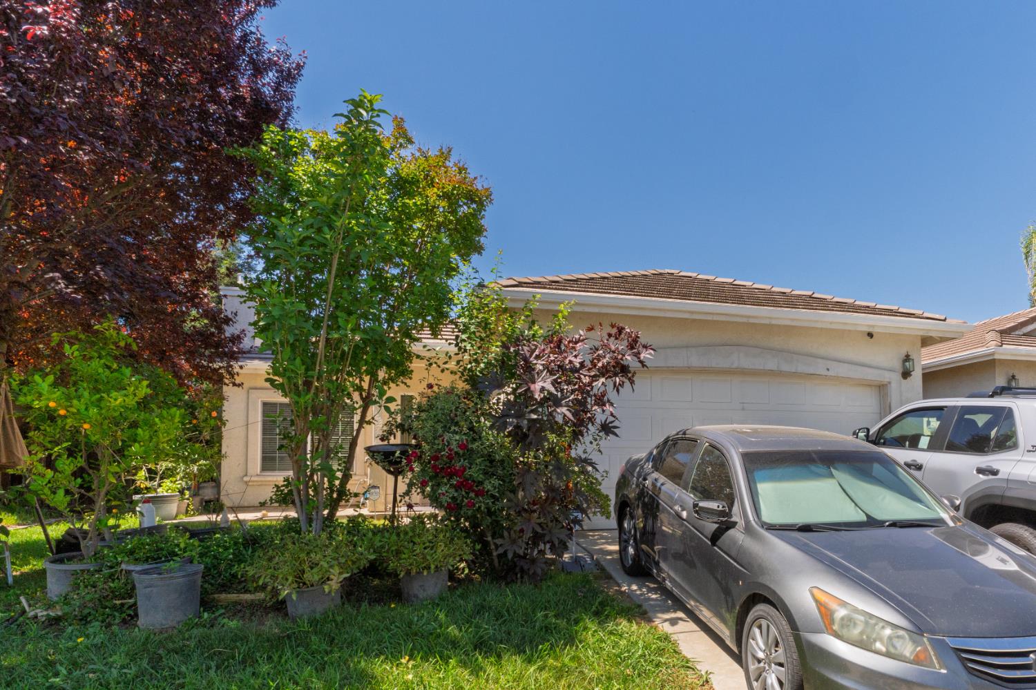 123 Manzanita Avenue Merced, CA 95341 - Photo 2 of 30 a front view of a house with garden