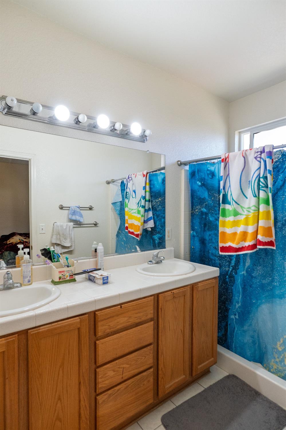 123 Manzanita Avenue Merced, CA 95341 - Photo 22 of 30 a room with a sink and a mirror